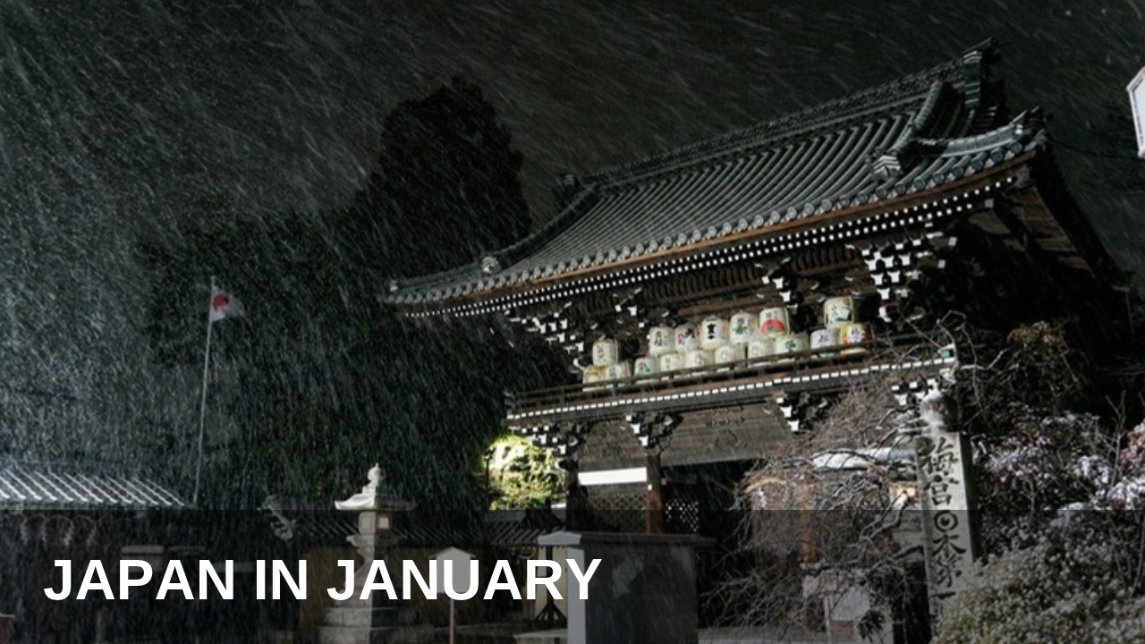 Japanese temple gate in falling snow at night