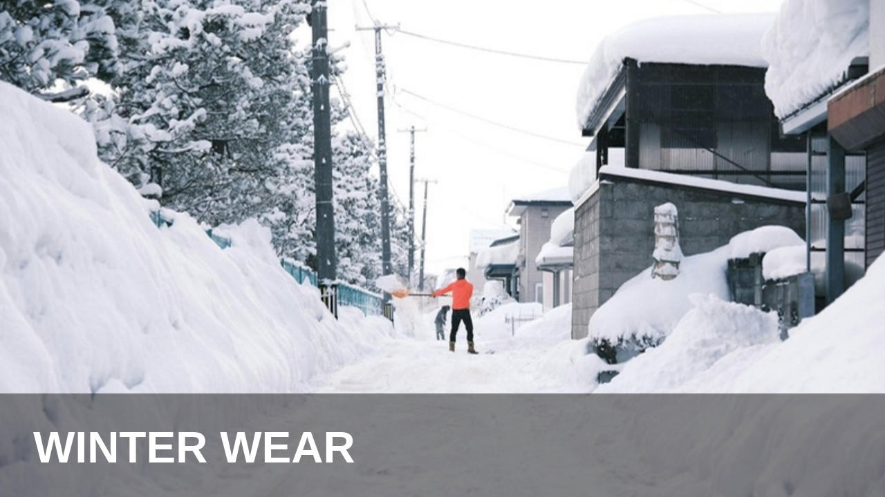 Person walking down a snow-covered street in Hirosaki, Japan